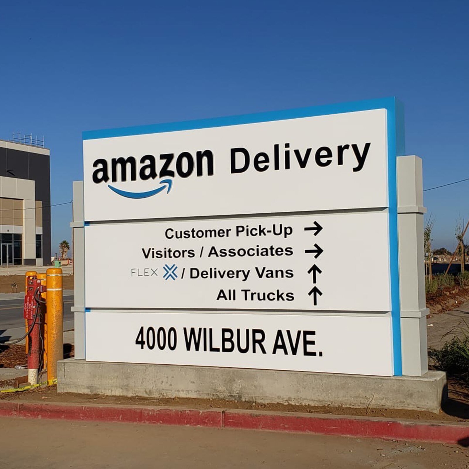 Installed Amazon Delivery monument sign with branded wayfinding on a commercial property