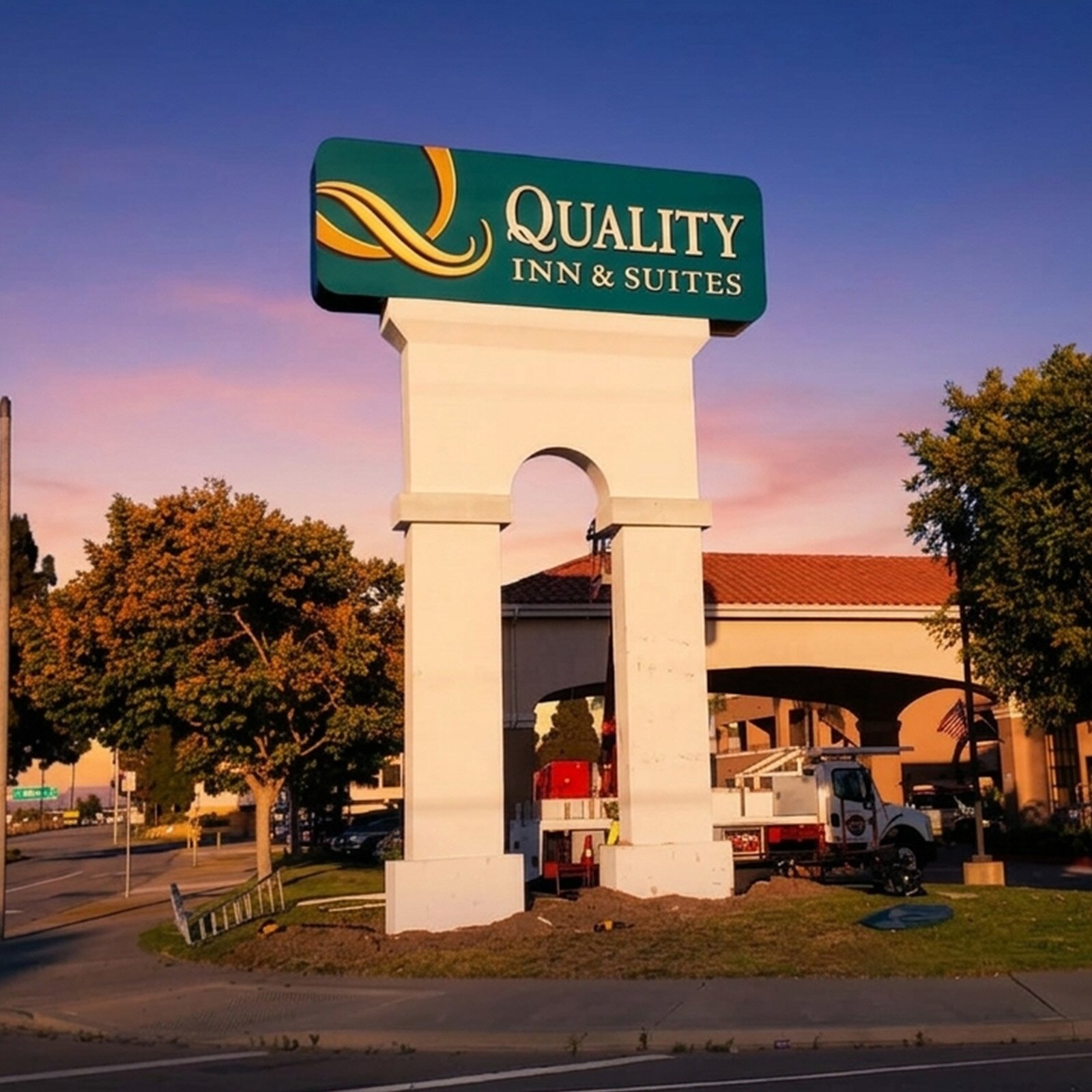 Quality Inn pylon sign installation in Torrance with crane and crew onsite