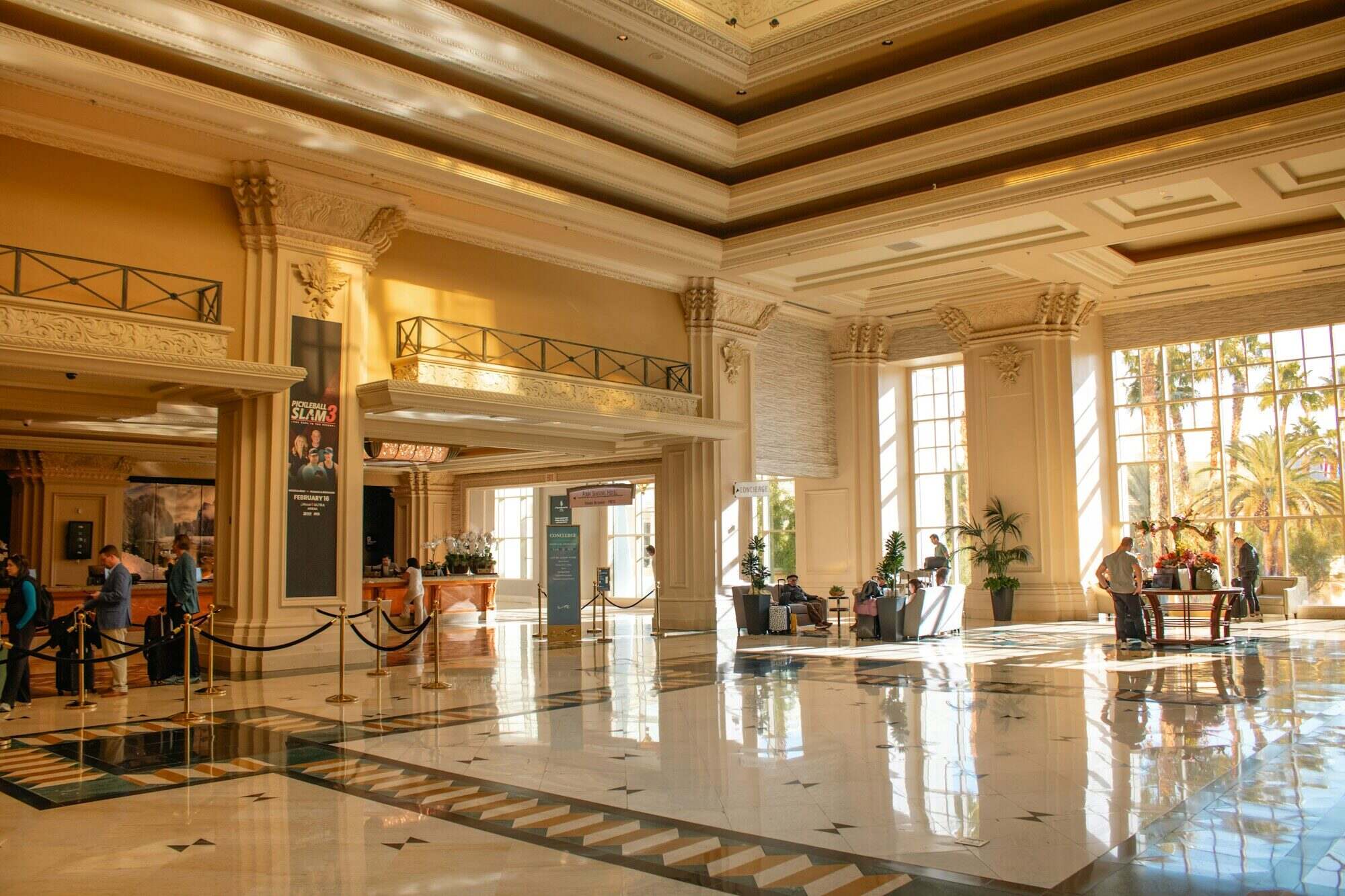 Grand hotel lobby with tall columns and polished marble floor