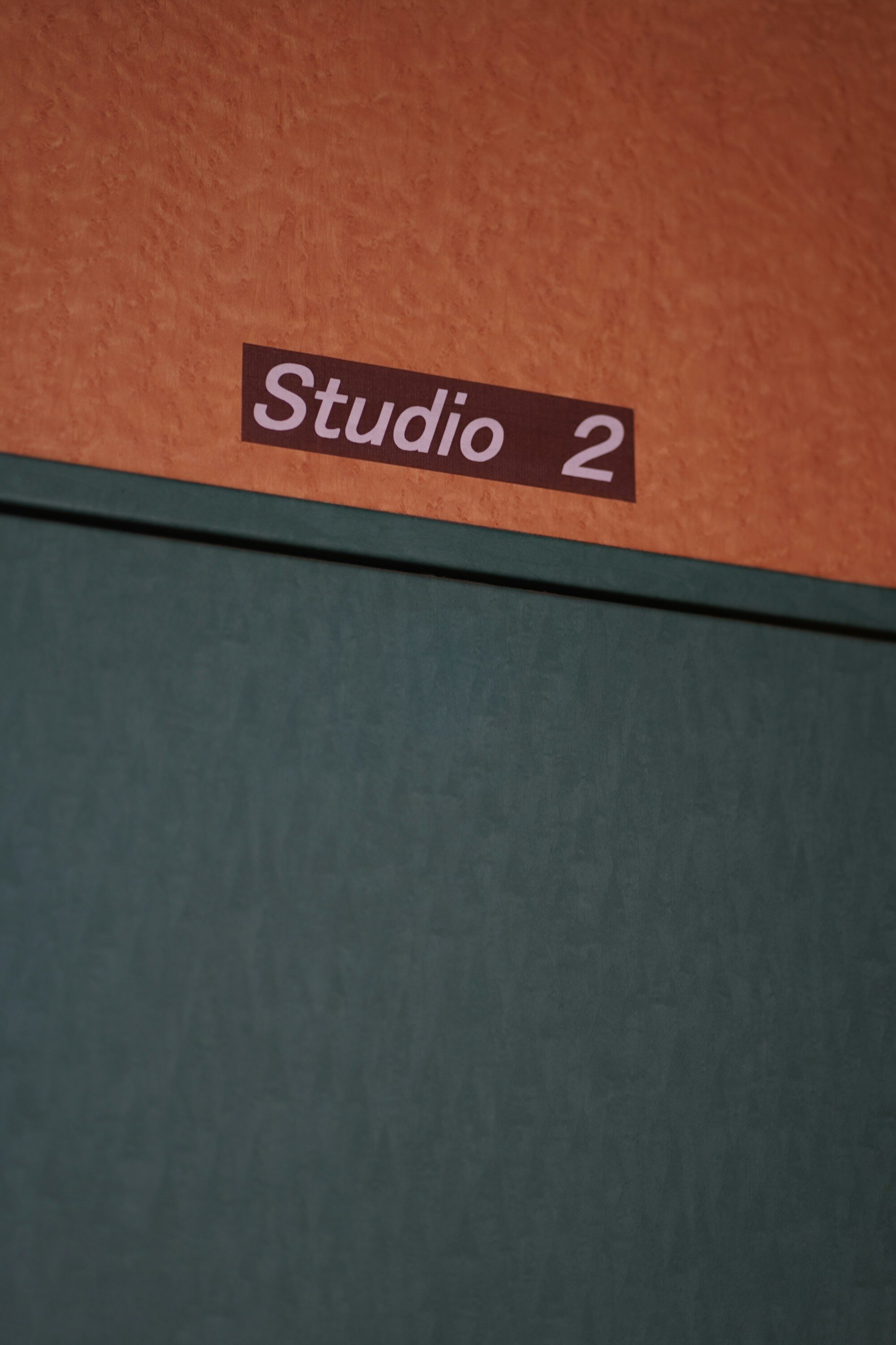 Interior suite number plaque on textured wall