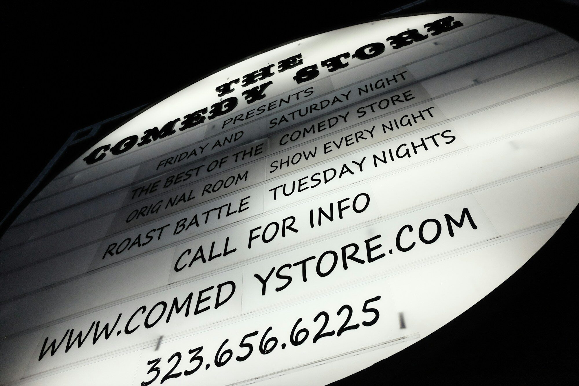 Close-up of multi-business tenant directory signage on a facade