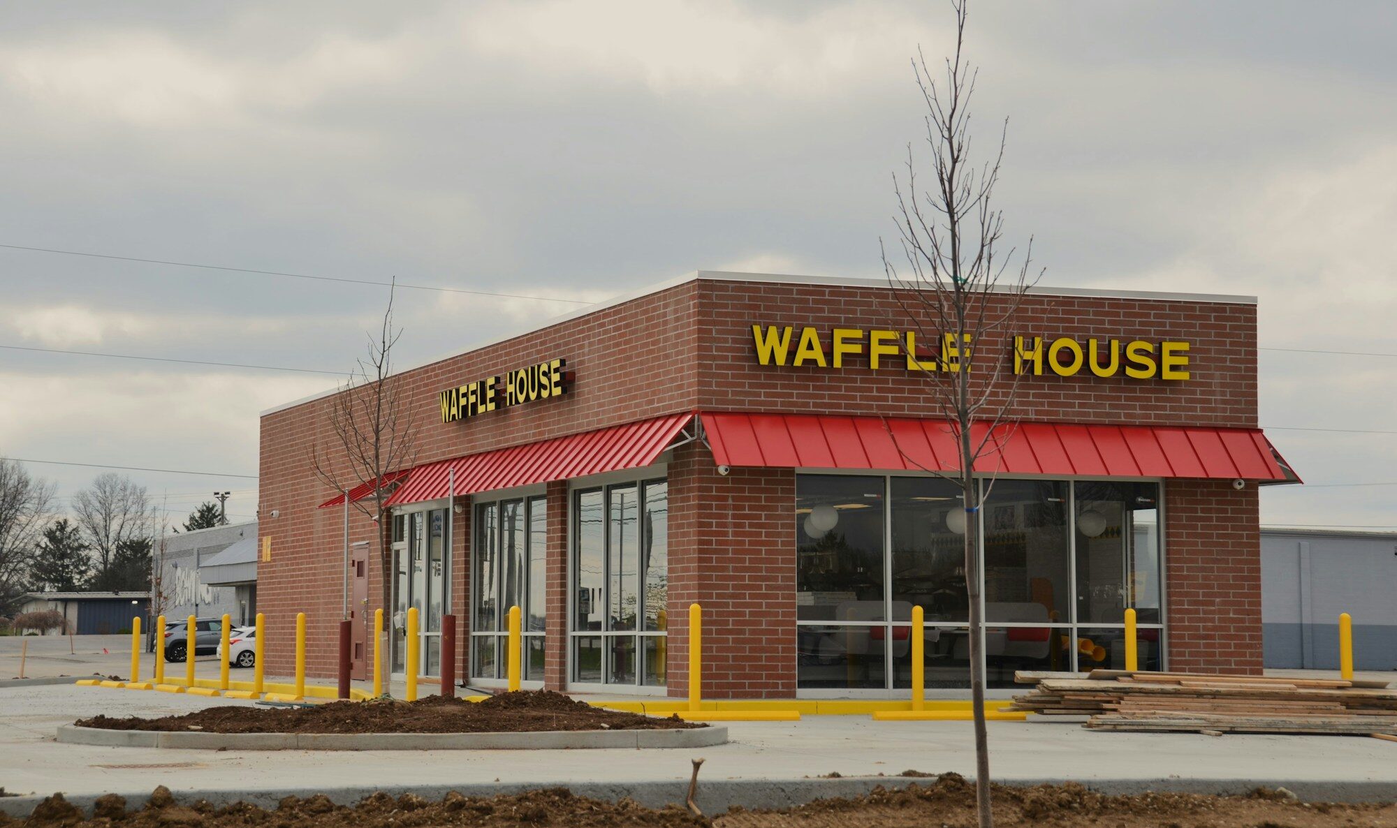 Red awning storefront with branded restaurant signage