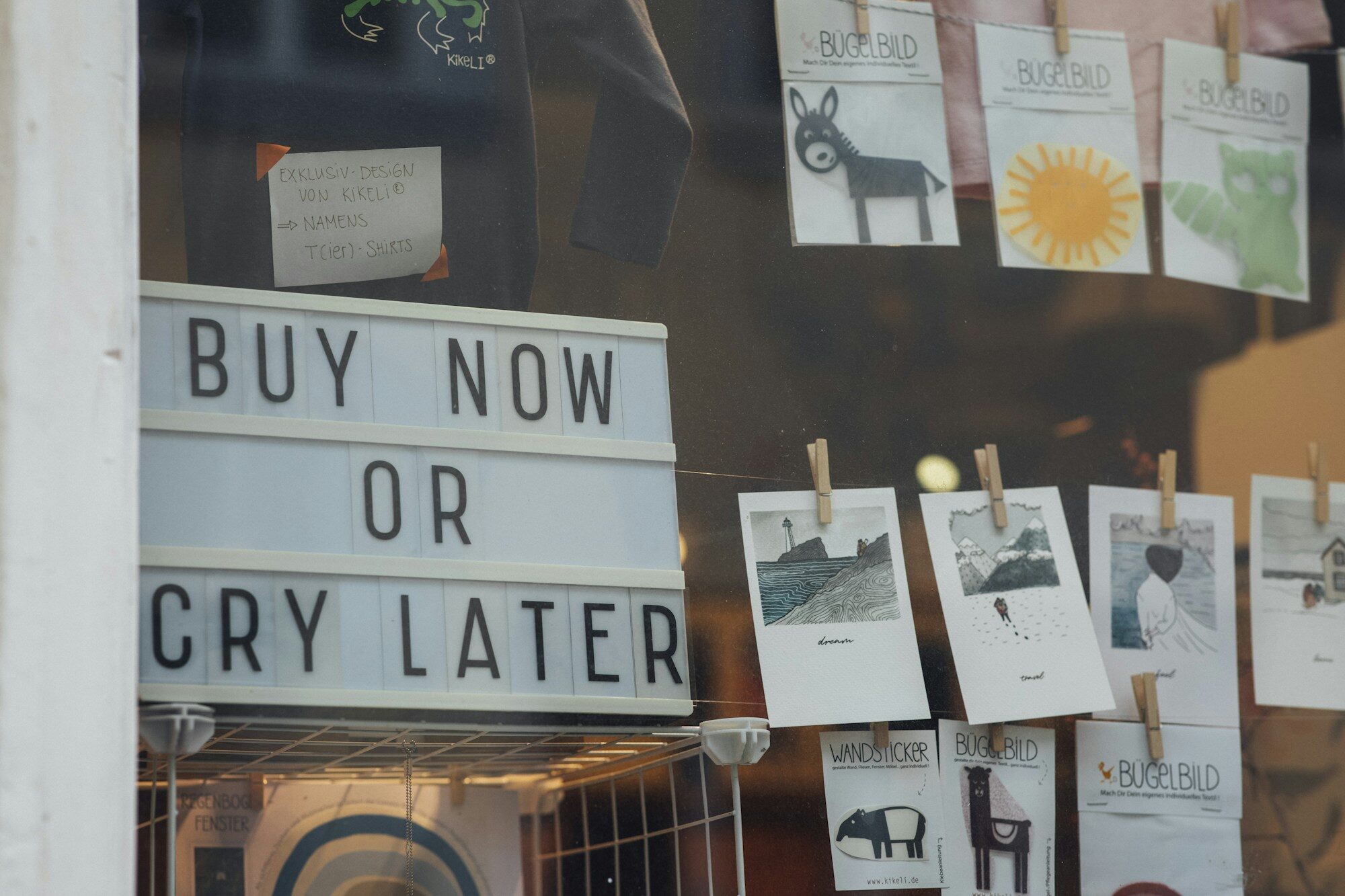 Retail storefront window with custom vinyl graphics and lettering