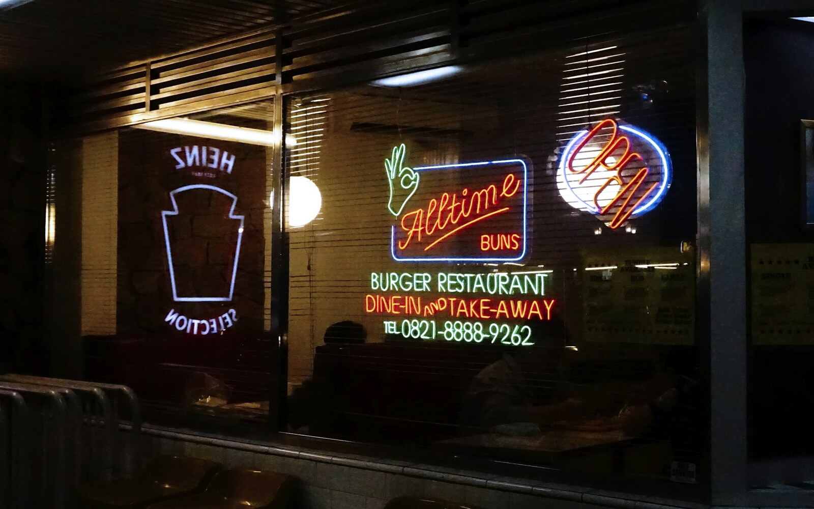 Illuminated restaurant neon signage at night