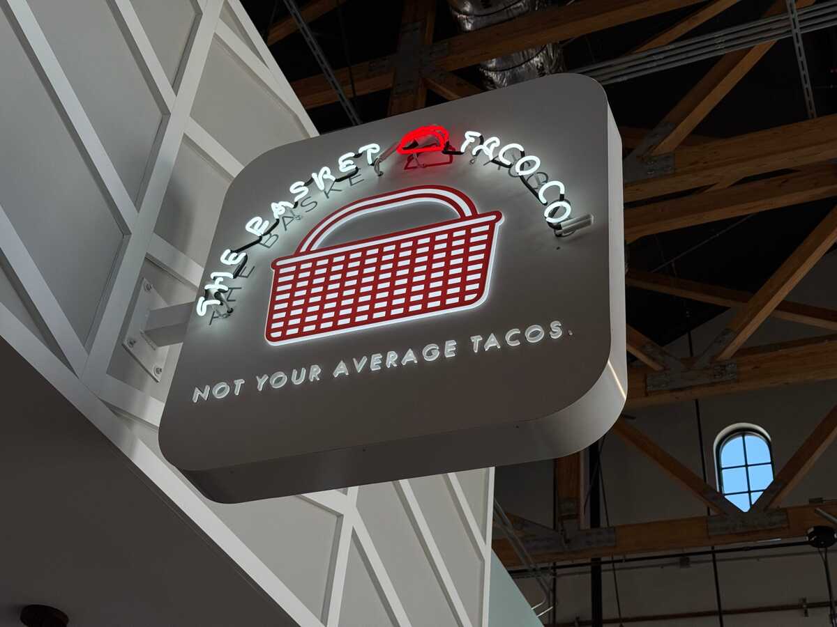 Double-sided blade sign projecting perpendicular from a Los Angeles storefront facade