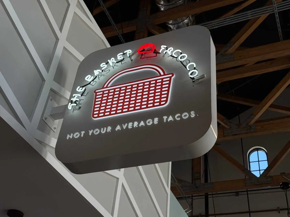 The Basket Taco Co neon blade sign at Rodeo Public Markets food hall