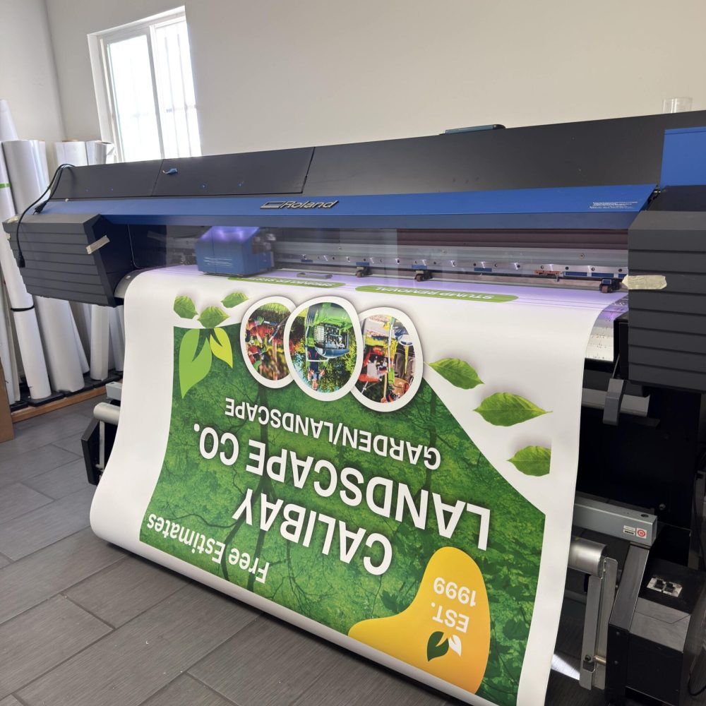 Wide-format Roland printer producing full-color vinyl graphics