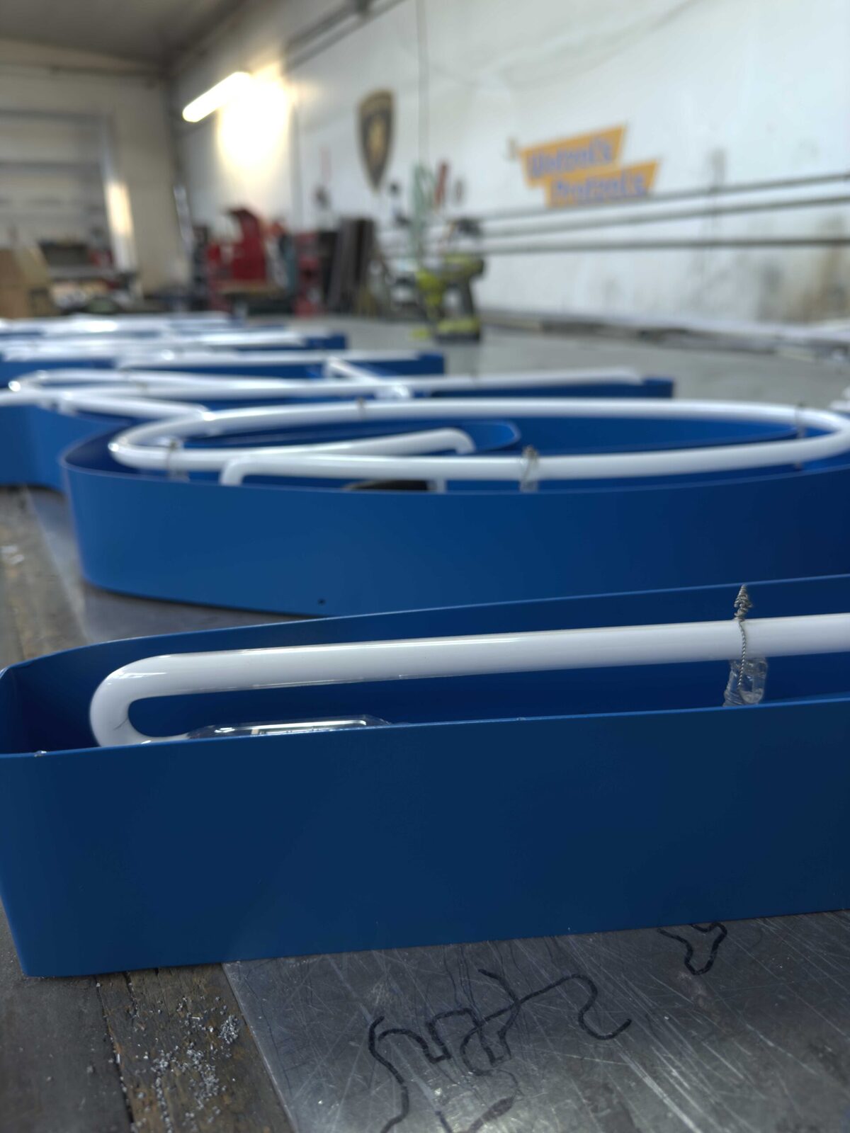 Wall-mounted cabinet sign during shop fabrication