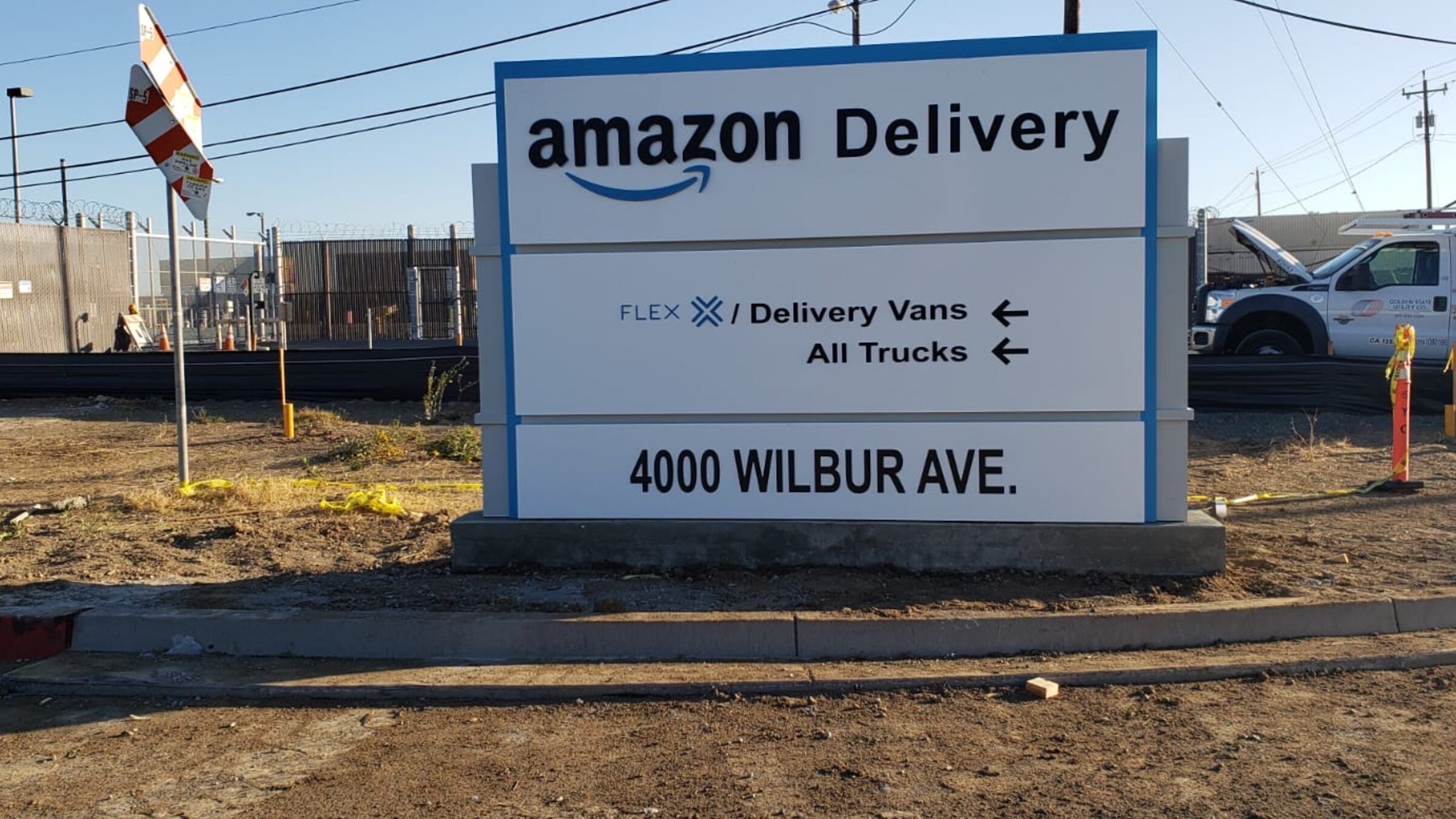 Amazon Delivery monument sign installed at a Los Angeles property entrance, stone-clad base with illuminated tenant panel