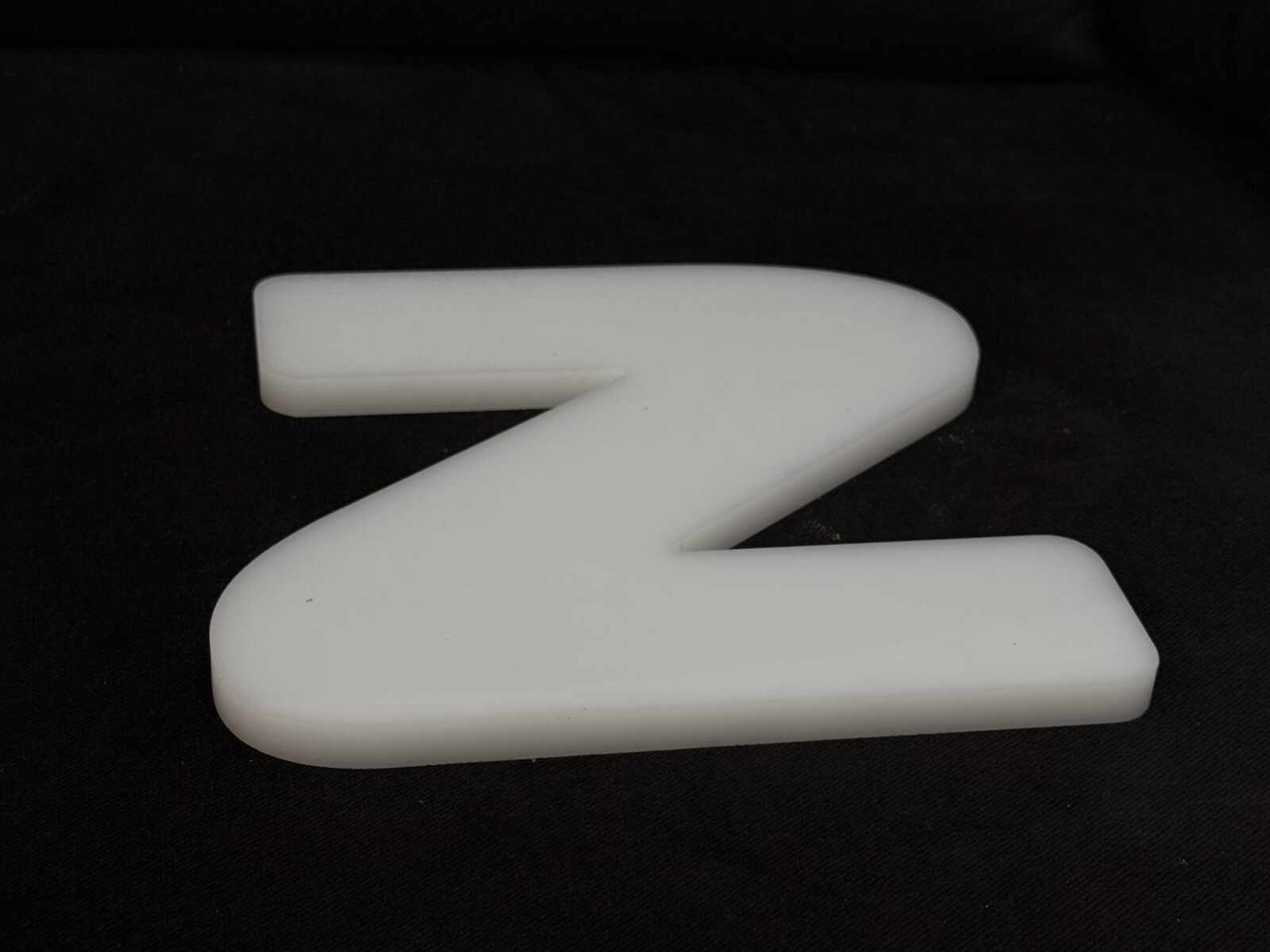 Pin-mounted acrylic lobby letters on a corporate reception wall