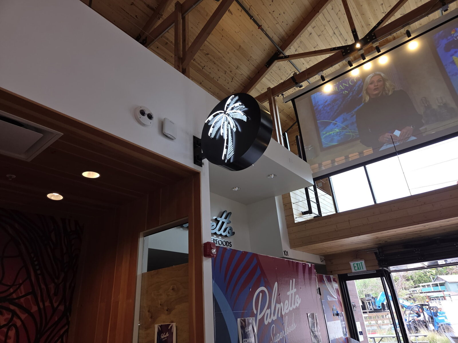 Cabinet sign installed high on a multi-tenant commercial building