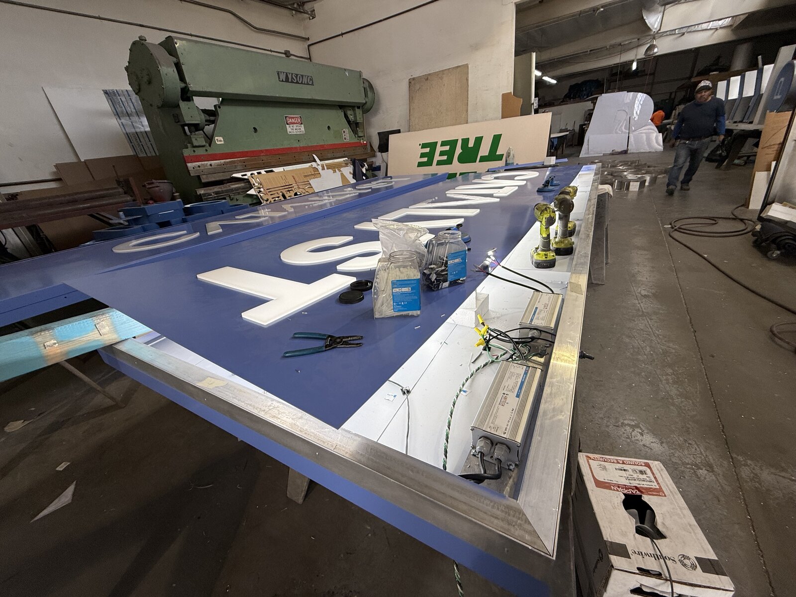 Aluminum cabinet sign during in-house fabrication at the Genius Signs shop