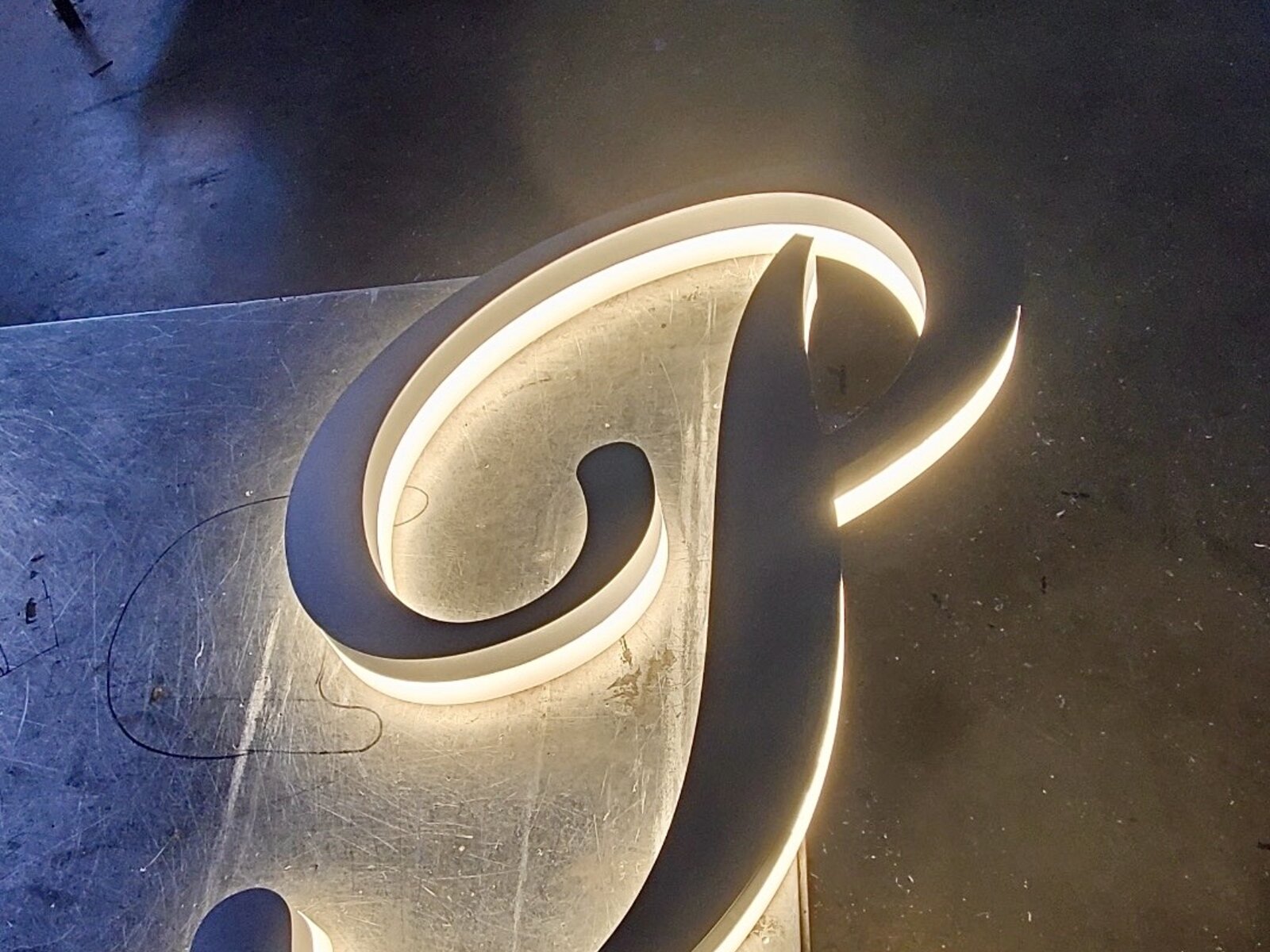 Edge lit channel letter sample showing the slim profile and perimeter LED glow