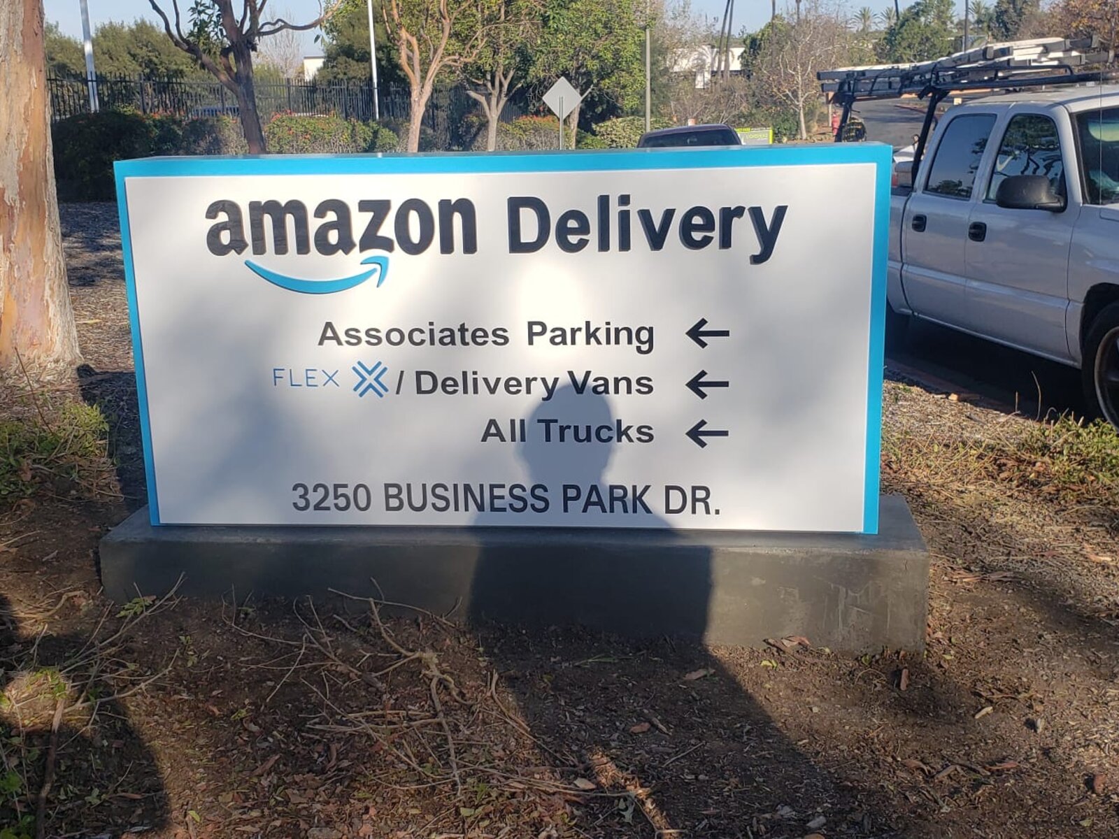 Amazon Delivery directional monument sign at 3250 Business Park Dr, aluminum cabinet on a concrete base