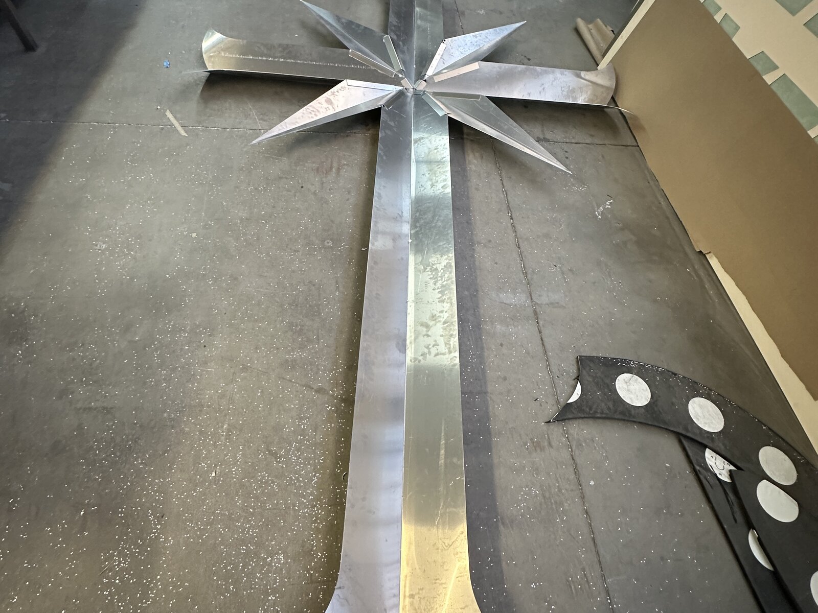 Stone-clad monument sign with cross graphic on a Southern California property