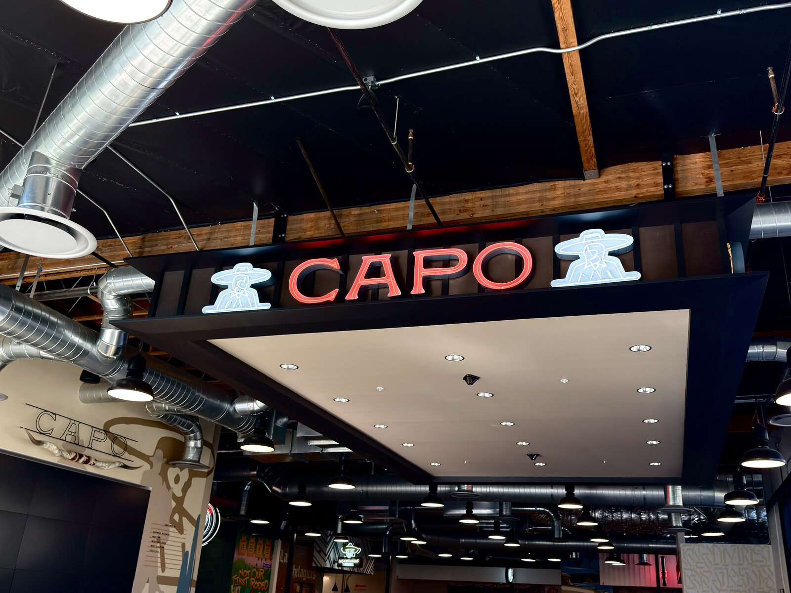 Open neon channel letters with exposed neon tubing glowing at night