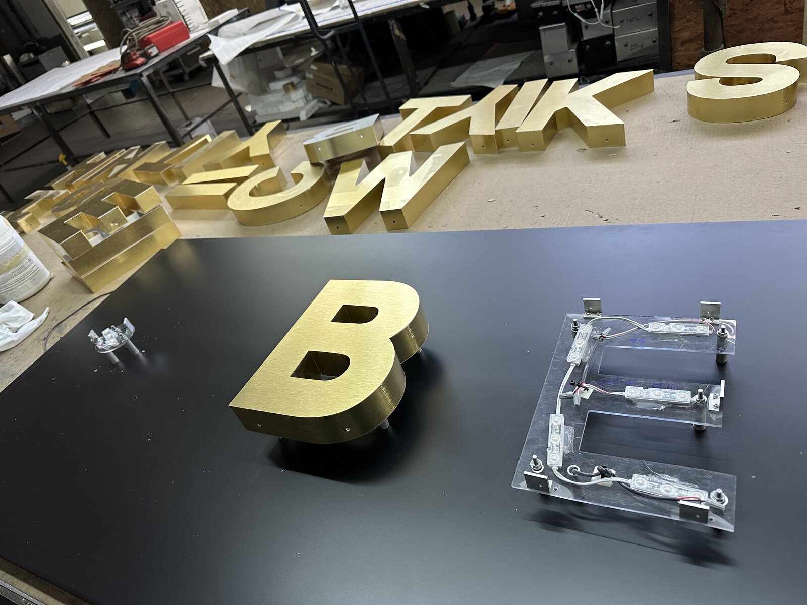 Metal-faced reverse channel letters on a Class A office building facade
