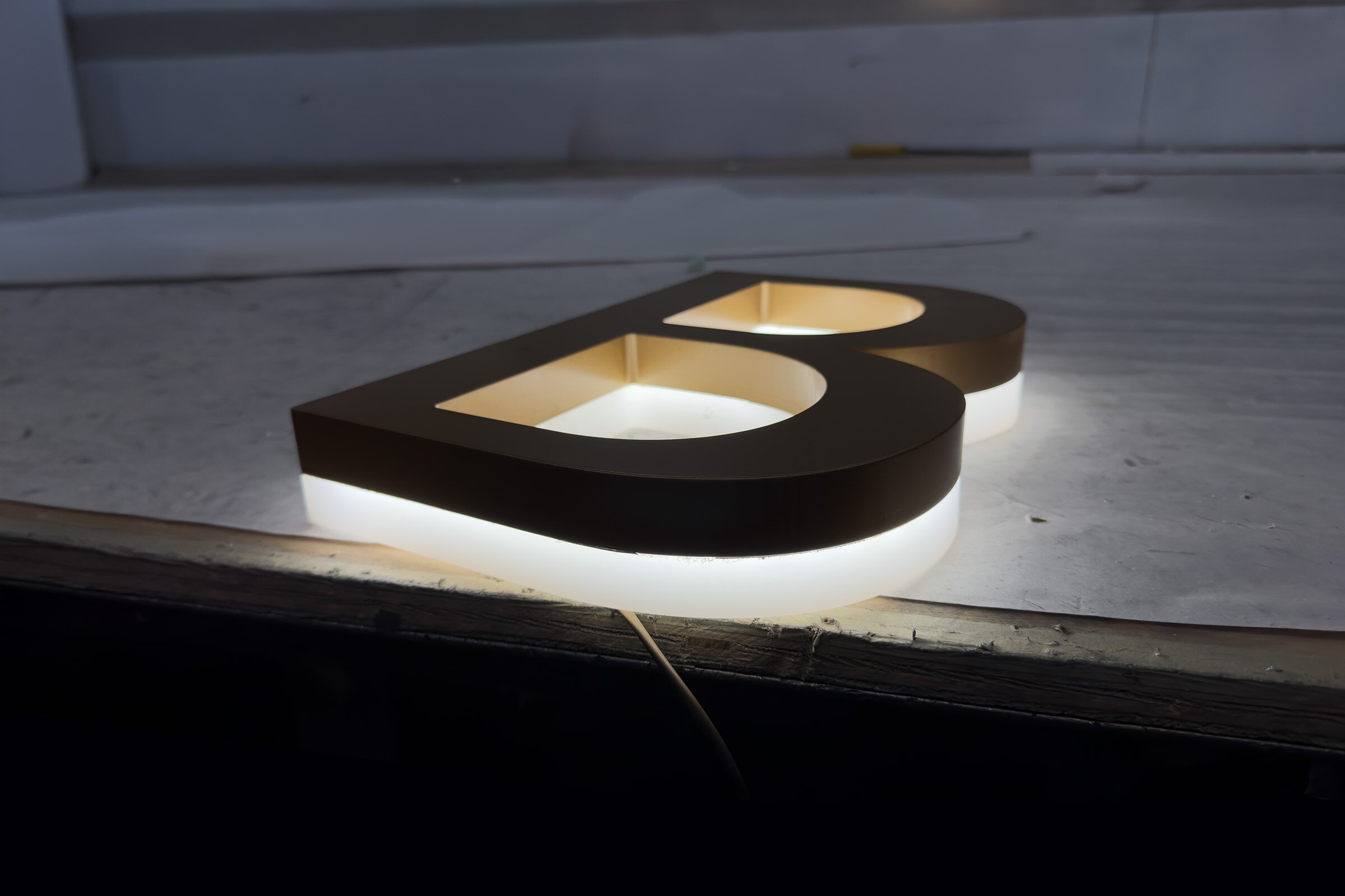 Ultra-slim edge-lit channel letters with a perimeter glow on a modern building