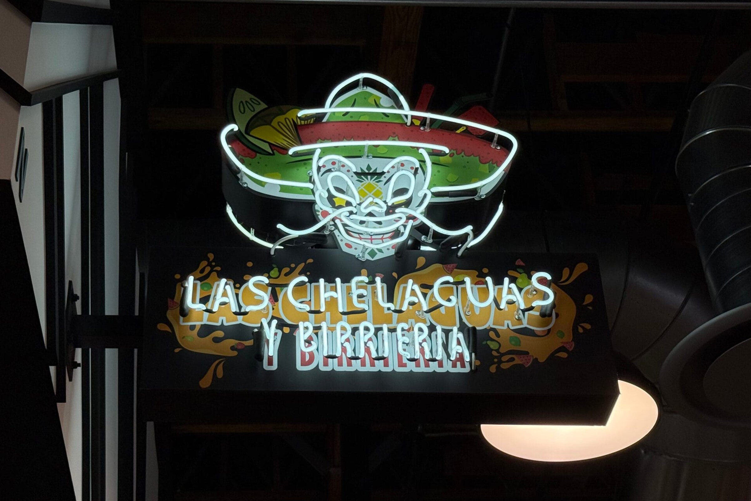 Hand-bent custom neon sign glowing warmly in a Los Angeles business window