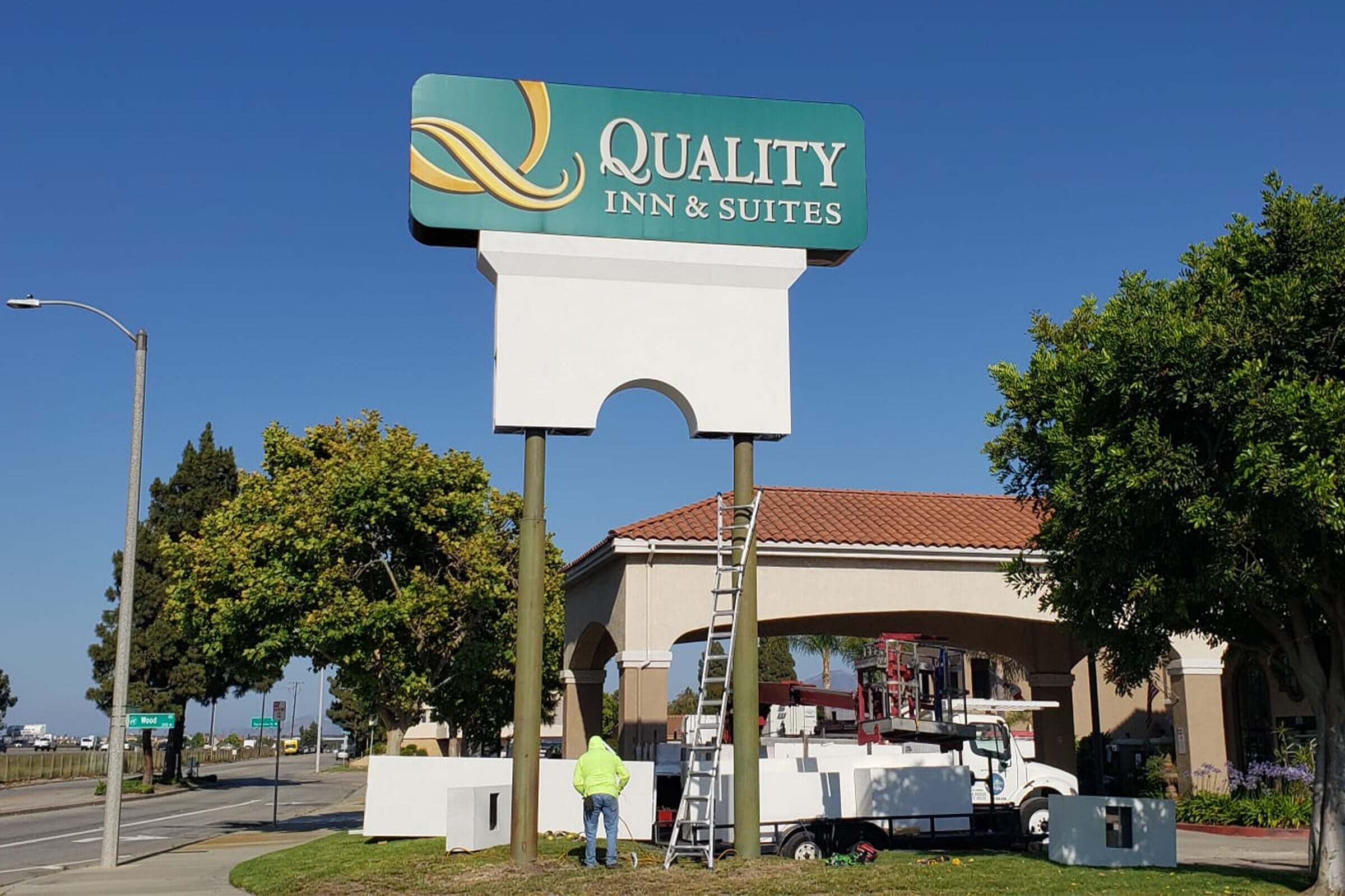 Tall multi-tenant pylon sign rising above a shopping center