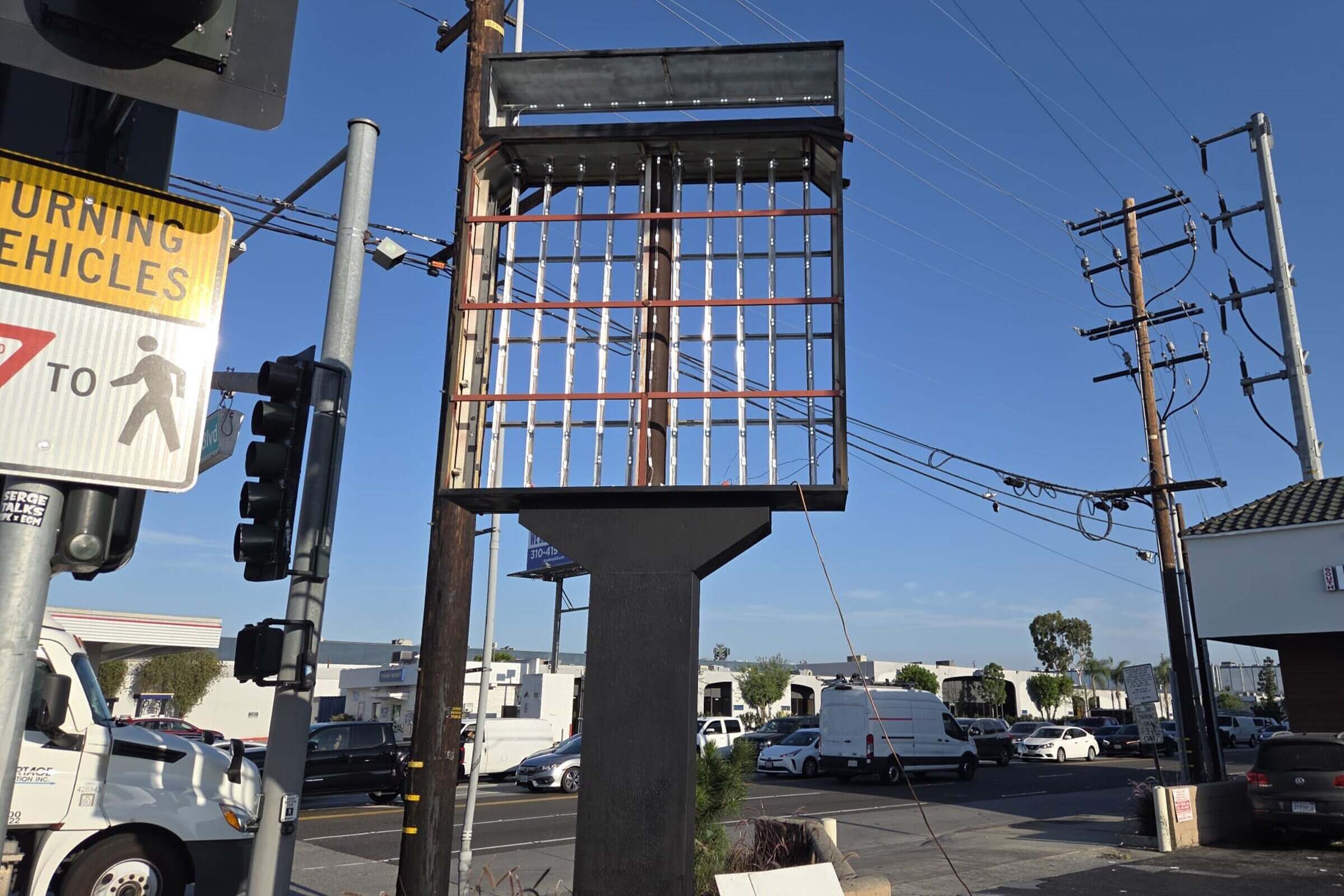Technician servicing and repairing a commercial sign