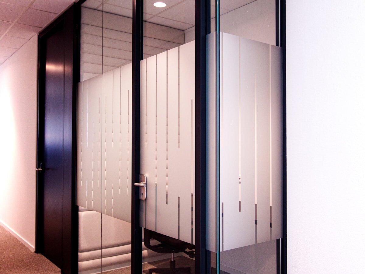 Frosted vinyl striping applied to glass office doors in a commercial interior